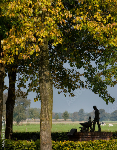 Statue of farmer with wheelbarrow. Village of Fort. Autumn. Fall. Zuidwolde Drenthe Netherlands. 