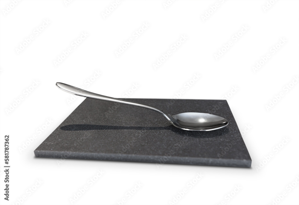an empty teaspoon on a small stone platform an empty teaspoon on a small stone platform