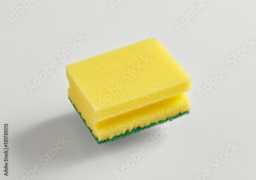 Kitchen dish sponge yellow and green isolated white background.