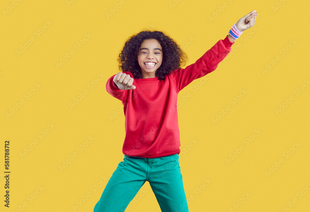 Happy child having fun in studio. Portrait of funny kid in casual