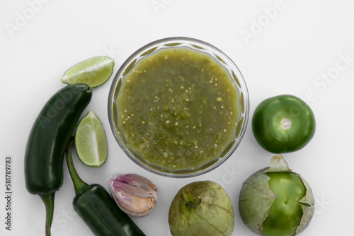 Tasty salsa sauce and ingredients on white background, top view