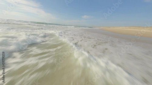 Aerial fpv racing drone flying over sea waters along beach, Soustons, Landes department in France photo