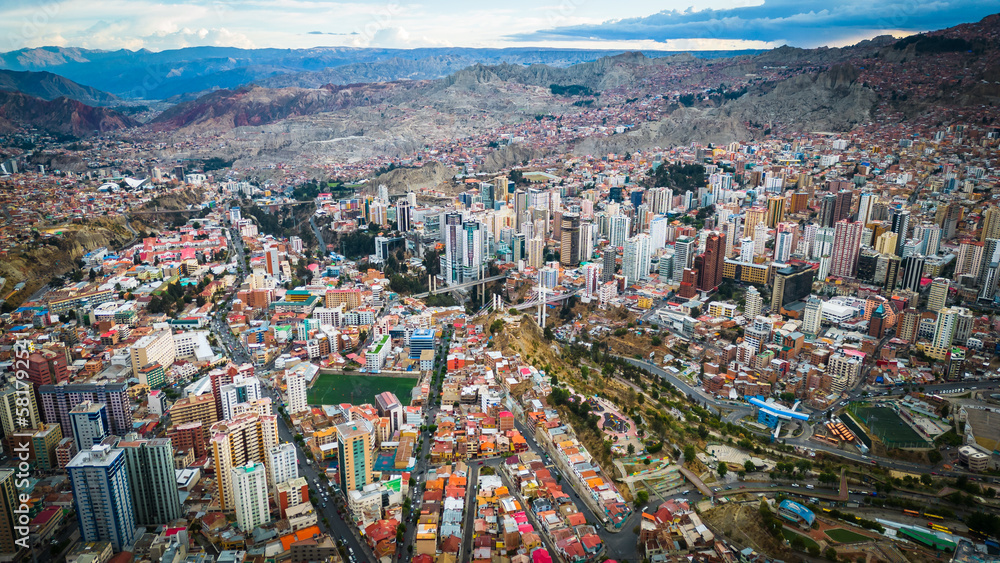 Aerial Drone Fly Above La Paz, Bolivia,  Crowder Metropolitan City, Houses, Skyscrapers and Andean Cordillera Mountain Range in the Background - obrazy, fototapety, plakaty 