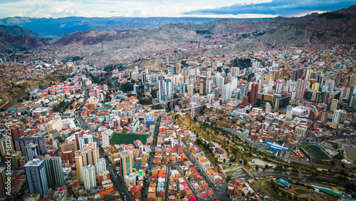 Aerial Drone Fly Above La Paz, Bolivia,  Crowder Metropolitan City, Houses, Skyscrapers and Andean Cordillera Mountain Range in the Background