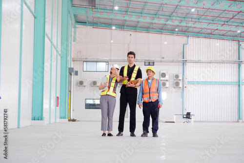 Engineers and employees walking in the warehouse.