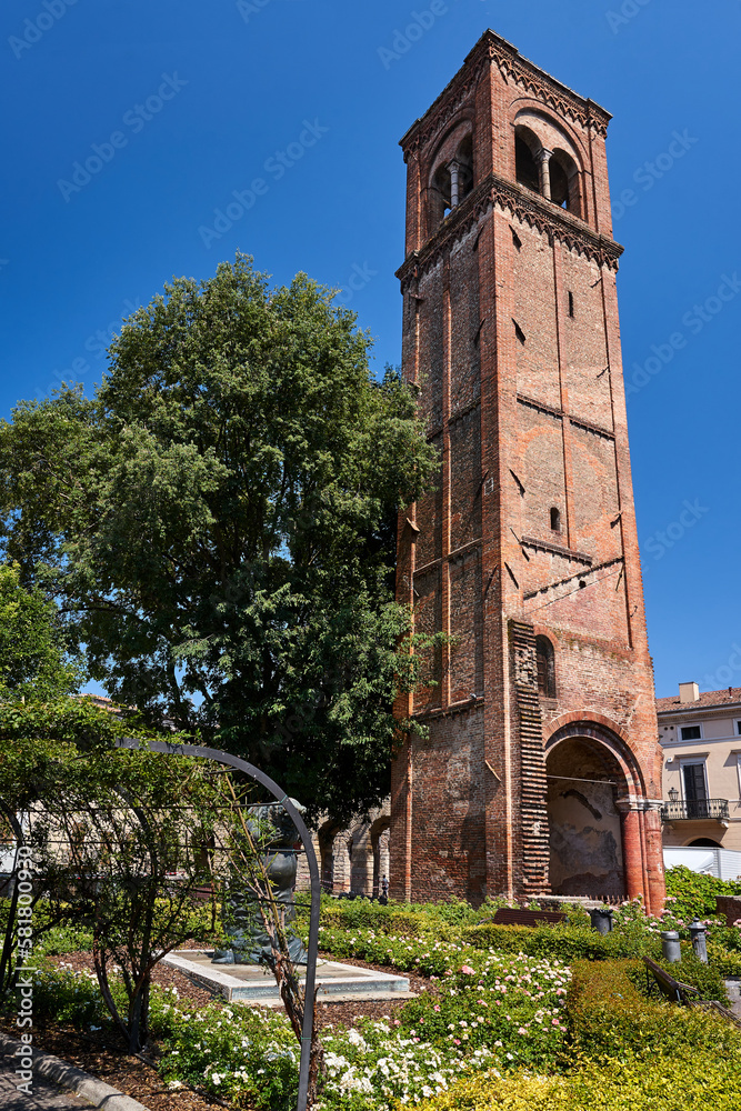 Brick, medieval belfry with the gate of a historic church in the city of Mantua