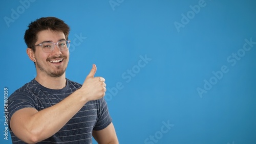Εκτύπωση καμβά Happy promoter lively young man 20s wears striped shirt pointing fingers over on