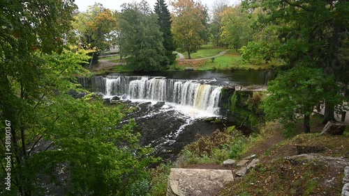 Waterfall with roaring and foaming water in Keila Joa park in autumn.
