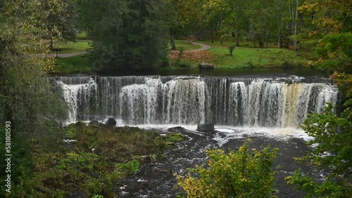 Waterfall with roaring and foaming water in Keila Joa park in autumn.