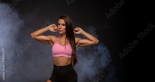 Determined fit sexy woman working out on smoky wave background