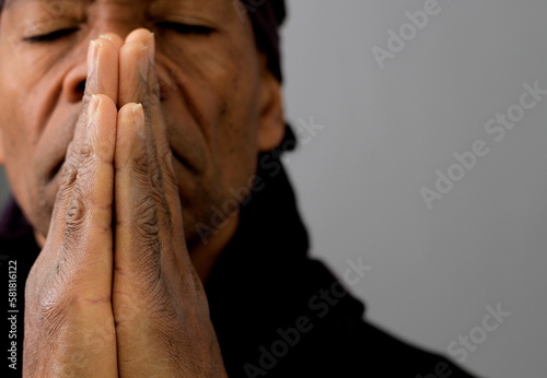 praying to god with man praying with grey background with people stock photo