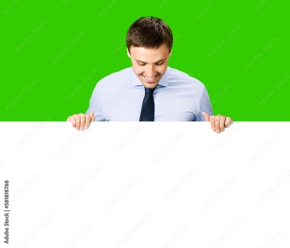 Portrait image business man professional bank manager in confident cloth. Businessman stand behind hang over, look at empty white banner signboard with copy space. Isolate green chroma key background Portrait image business man professional bank manager in confident cloth. Businessman stand behind hang over, look at empty white banner signboard with copy space. Isolate green chroma key background