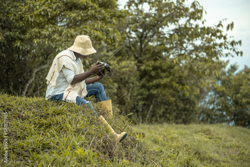 afro farmer man listening to radio