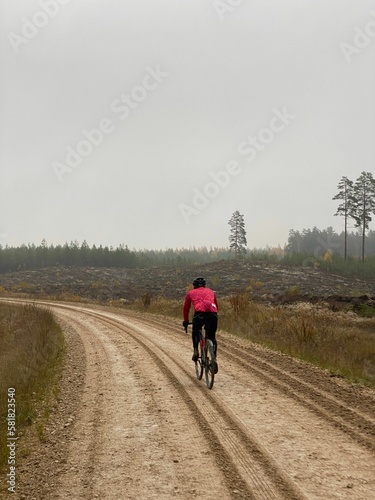 Back view of cyclist riding on road