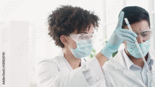 scientists examining control samples in the laboratory .