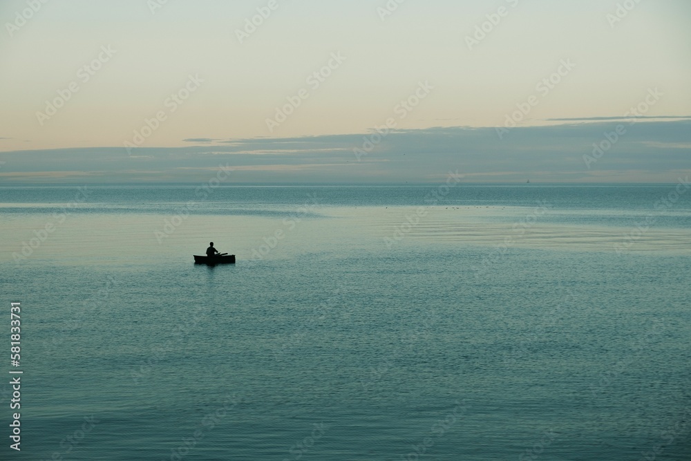 Beautiful view of a lonely fisher in a boat