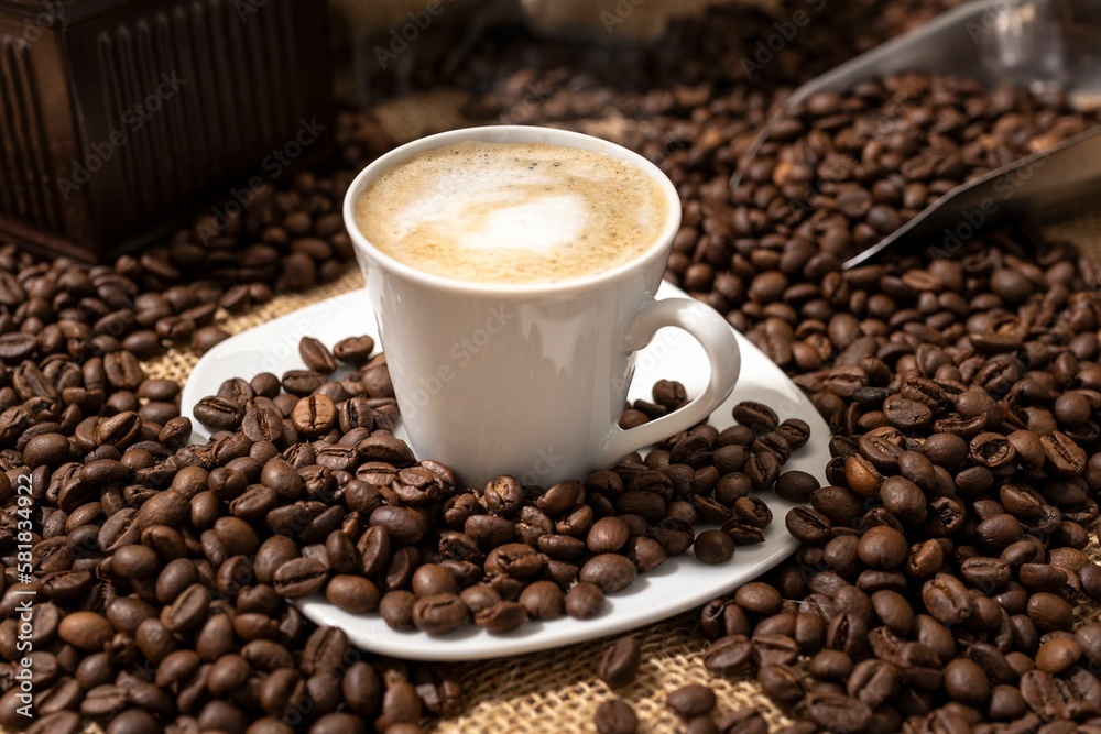 Cappuccino or Coffee with milk cup and roasted beans on table Cappuccino or Coffee with milk cup and roasted beans on table