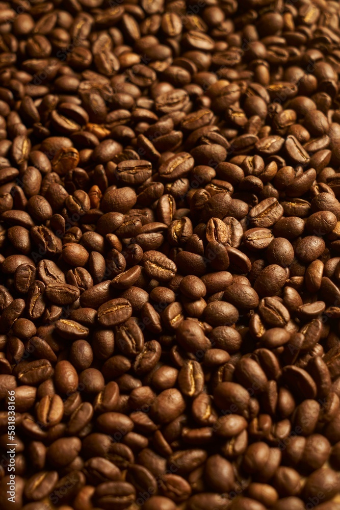 Closeup vertical shot of freshly-roasted coffee beans Closeup vertical shot of freshly-roasted coffee beans