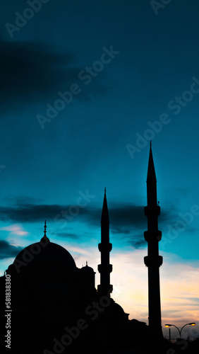 Eminonu Yeni Cami or New Mosque at sunset. Islamic concept vertical photo