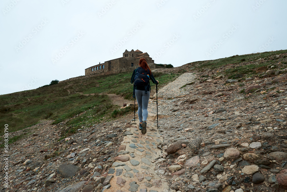 Anonymous woman walking towards castle