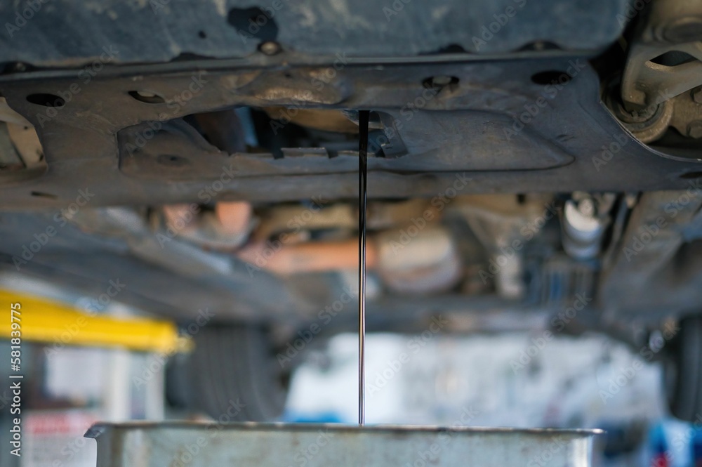 car workshop, car oil change in a garage by a car mechanic car workshop, car oil change in a garage by a car mechanic