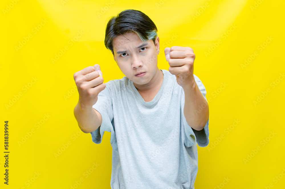 asian man screaming madly and angrily. young indonesian man threatening, accusing and looking for fight.
