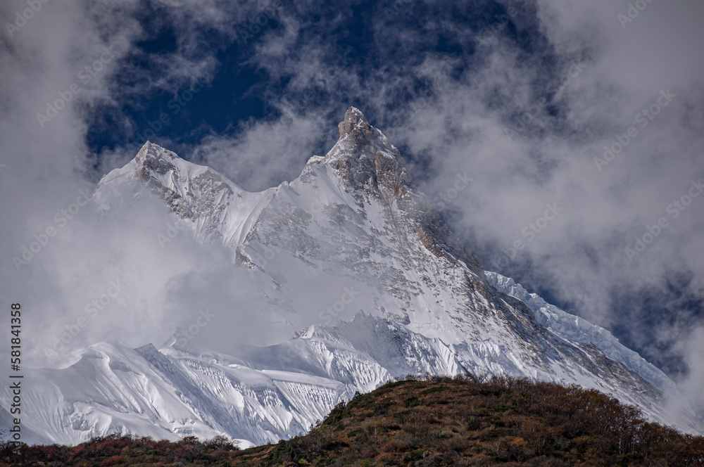 View of Manaslu mountain Main Summit and its East Pinnacle peak, as seen from the  trail  to Samagaon village, Manaslu Circuit trek, Gorkha district, Nepal Himalayas, Nepal 