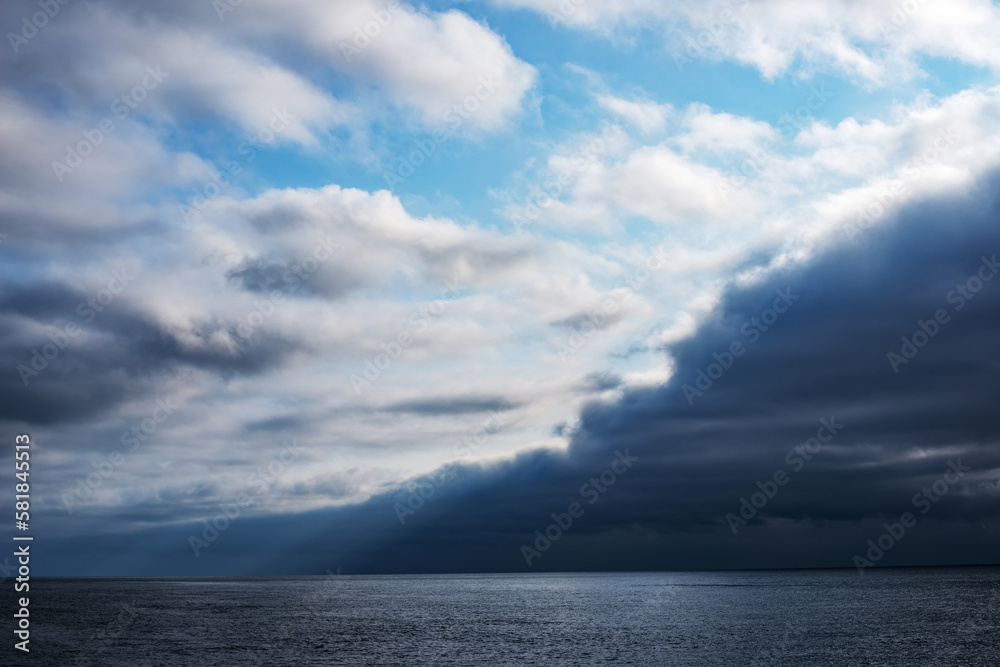 Dark atmospheric front over the sea diagonally dividing the frame