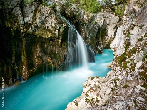 Long exposure waterfall at the Great Soca Gorge in Slovenia surrounded by mossy rocks