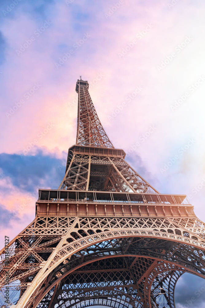 The Eiffel Tower in Paris against the backdrop of a beautiful evening sky.