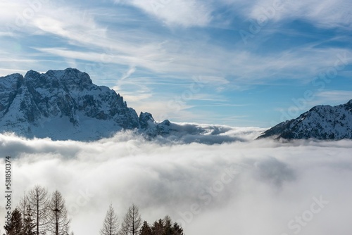 Landscape view of the clouds under mountain peaks in the Julian alps in Italy