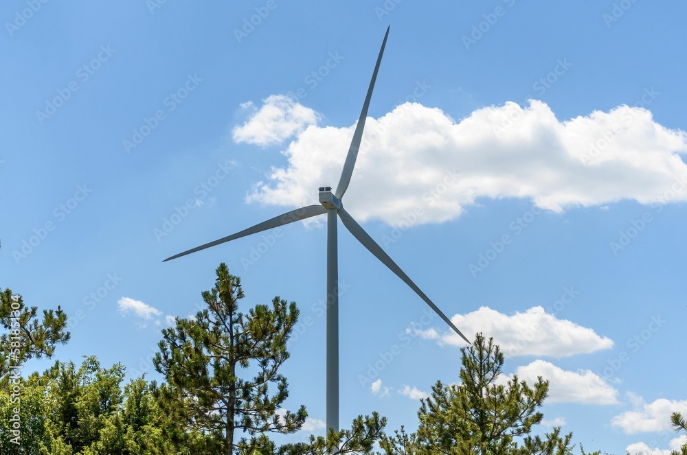 Wind turbine against blue sky on a sunny day