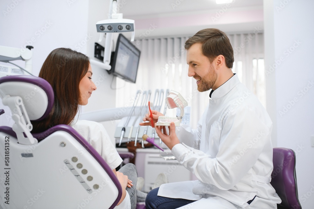 The concept of diagnosis and treatment of tooth disease. Doctor shows a model of a sick tooth. The concept of diagnosis and treatment of tooth disease. Doctor shows a model of a sick tooth.
