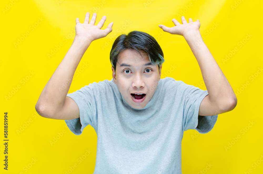 portrait of Young asian man open arms, hands and point finger to present something. proud Asian man with a smile offers, presents and advertise an advertisement portrait of Young asian man open arms, hands and point finger to present something. proud Asian man with a smile offers, presents and advertise an advertisement