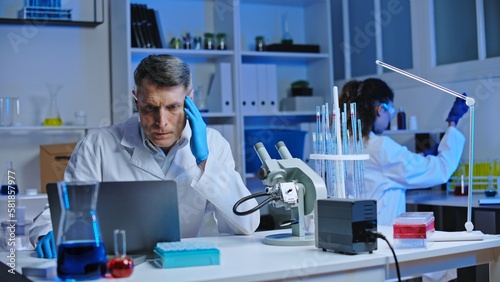 Tableau sur toile Nervous laboratory worker noticing mistake in test results on laptop, negligence