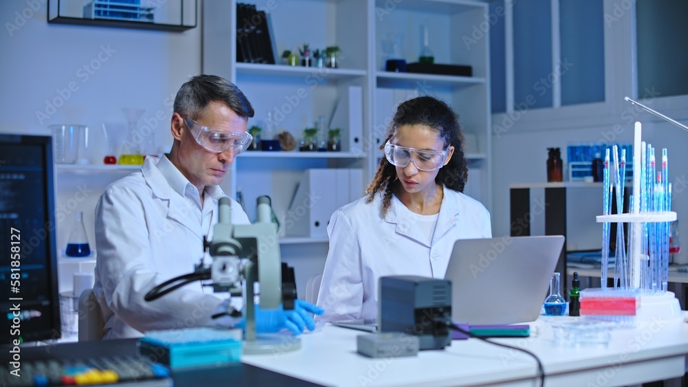 Scientists of food quality control laboratory examining samples, making tests Scientists of food quality control laboratory examining samples, making tests