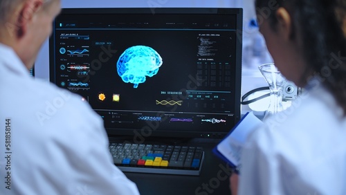 Team of clinical scientists studying 3D brain image, neurology diagnostics lab