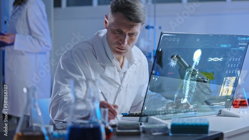 Health laboratory worker studying holographic human skeleton image, diagnostics