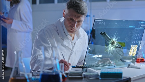 Microbiology laboratory worker describing virus looking at simulation on holographic screen