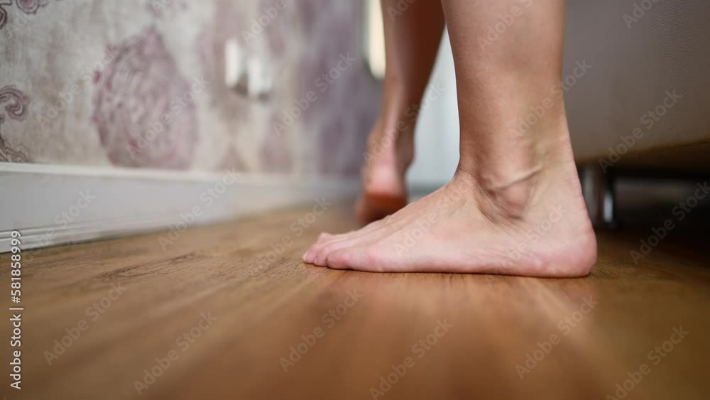 Beautiful Female Bare Legs Descend from Bed to the Floor in the Morning. Woman Woke Up. Close-up, Unrecognizable Person, Slow Motion. Beautiful Female Bare Legs Descend from Bed to the Floor in the Morning. Woman Woke Up. Close-up, Unrecognizable Person, Slow Motion.