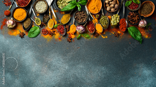 Fototapeta Naklejka Na Ścianę i Meble -  Variety of spices and herbs on kitchen table. Top view. Free space for text.