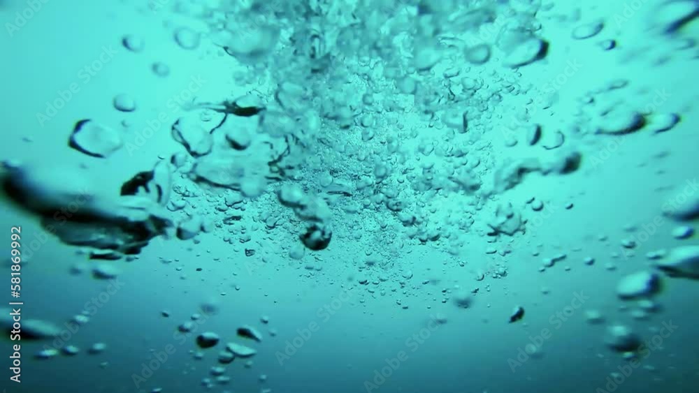 Air Bubbles Rising Towards Sea Surface - Low Angle View. Blue Sea Underwater With Air Bubbles. Nature Backgrounds. Underwater Shot of Exhaled Scuba Diver Air Bubbles Rising to Ocean Surface. Air Bubbles Rising Towards Sea Surface - Low Angle View. Blue Sea Underwater With Air Bubbles. Nature Backgrounds. Underwater Shot of Exhaled Scuba Diver Air Bubbles Rising to Ocean Surface.