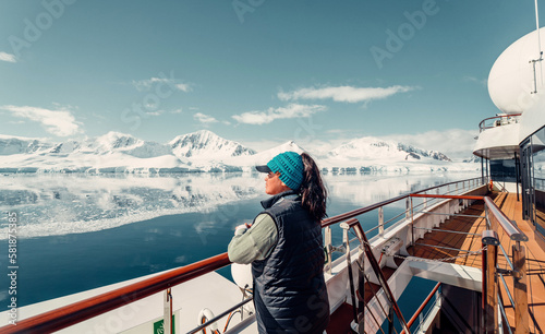 Female Tourist On Huge Luxury Antarctica Cruise Ship Looking Out At The Stunning Scenic Arctic Landscape, 