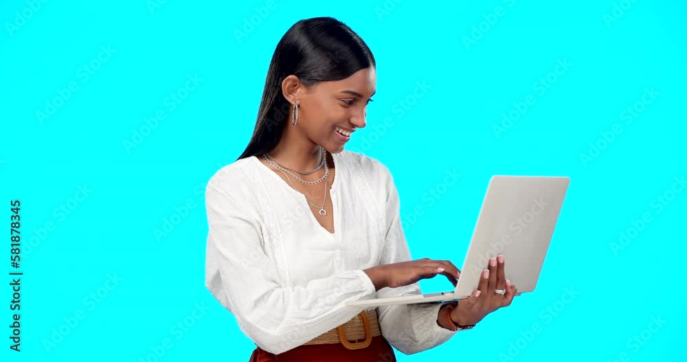 Business woman, laughing and laptop in a studio reading a funny email on computer. Isolated, blue background and young Indian female with happiness writing on a website with a smile feeling happy Business woman, laughing and laptop in a studio reading a funny email on computer. Isolated, blue background and young Indian female with happiness writing on a website with a smile feeling happy