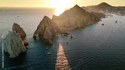 Sunset high view aerial surround of El Arco Cabo San Lucas Arch, Los Cabos Mexico. Orange sky. 
