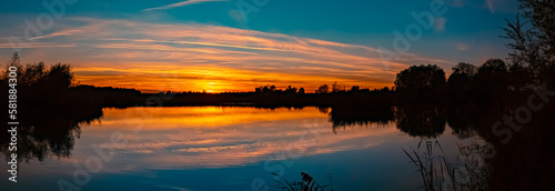 High resolution stitched sunset panorama with reflections near Wallersdorf, Bavaria, Germany © Martin Erdniss