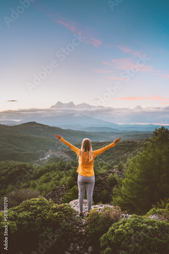 Woman tourist outdoor hiking solo enjoying sunset mountains view travel healthy lifestyle girl raised hands alone active summer vacations harmony with nature