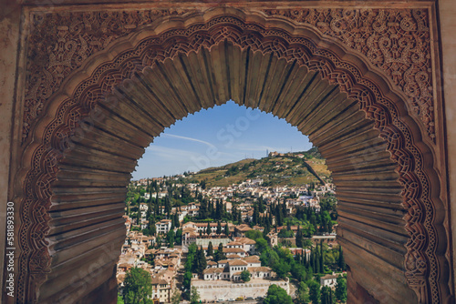 View to Granada from a moorish window with islamic details in Generalife, Alhambra, Granada, Andalusia, Andalucia, Spain