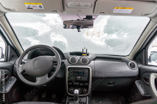 car windshield under a layer of snow  winter frozen car window