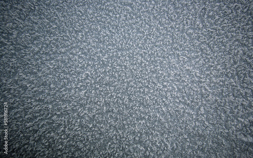 Top down Macro shot of Ice crystals on Car hood that looks like frozen carpet. Sharp in the center and soft focus around the outside.